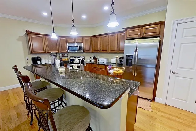 a kitchen with a table chairs refrigerator and microwave