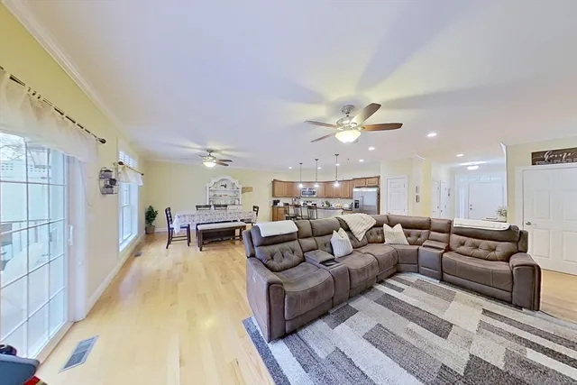 a living room with furniture and a chandelier