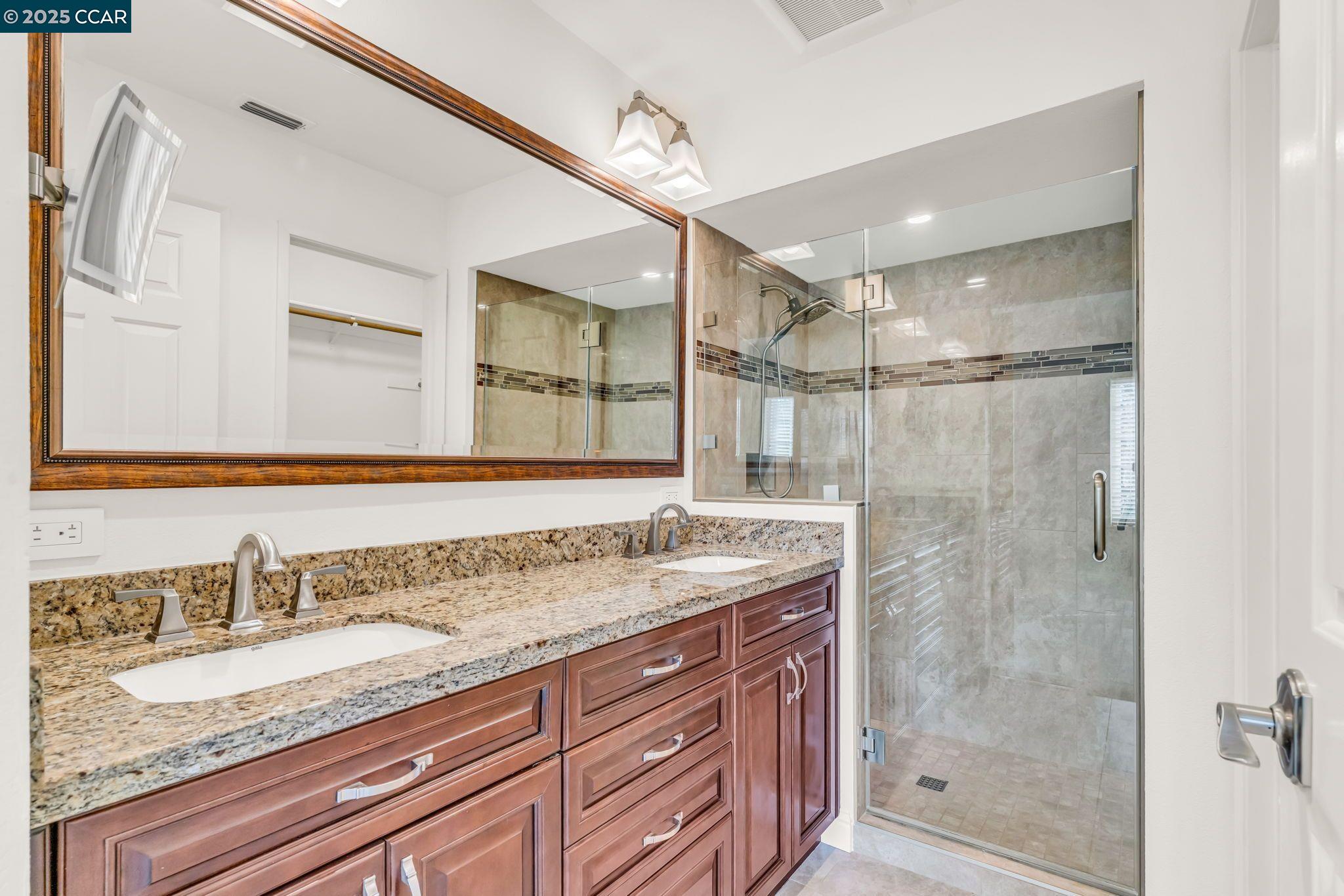 440 Canyon Woods Place, Unit C San Ramon, CA 94582 - Photo 7 of 17 a bathroom with a granite countertop sink mirror and double