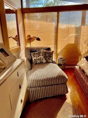 a bedroom with a bed and large window