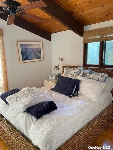 a bedroom with a bed and a large mirror