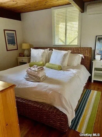 a bedroom with a bed and window