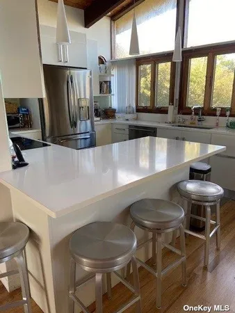 a kitchen with a table chairs stove and refrigerator