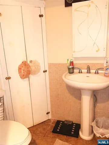 a bathroom with a sink a toilet and mirror