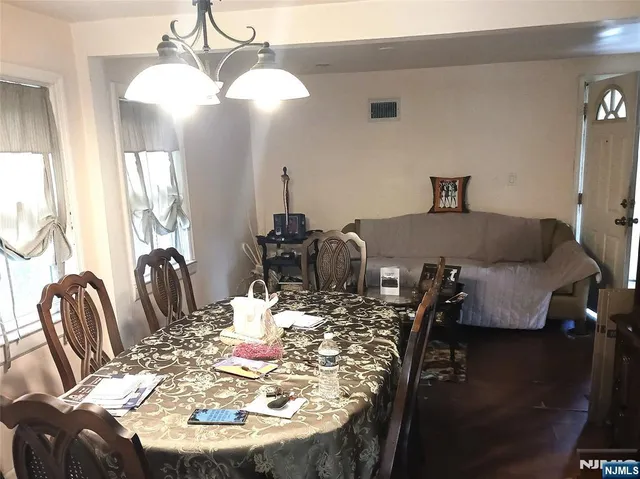 a dining room with furniture and wooden floor