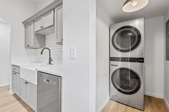 a bathroom with a sink a washer and dryer