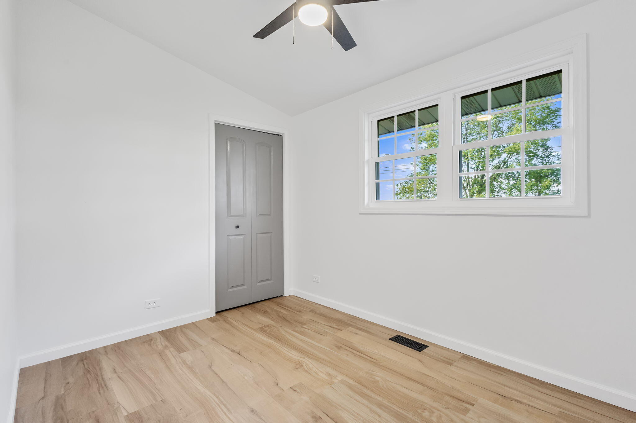 229 West Wood Road Rensselaer, IN 47978 - Photo 17 of 23 an empty room with a window and wooden floor