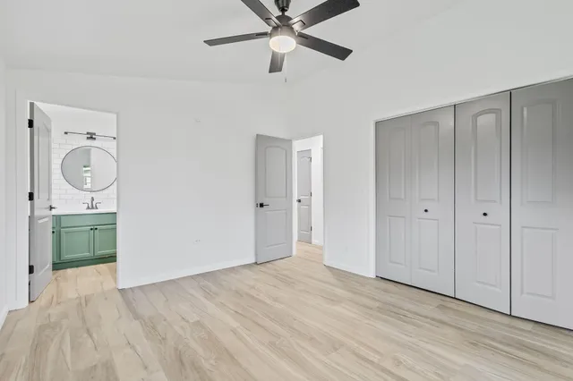 a view of a room with a sink and a chandelier fan