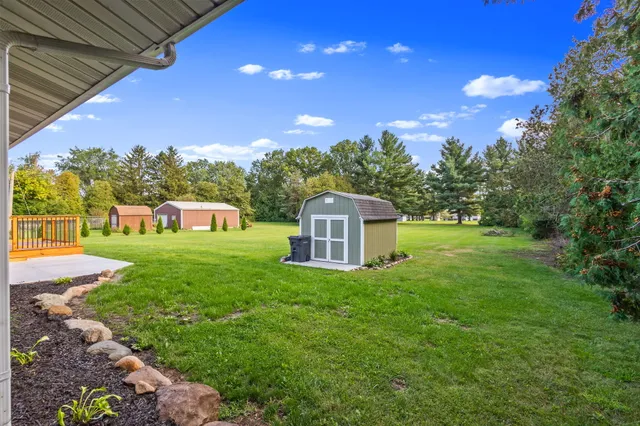 a front view of a house with yard and green space