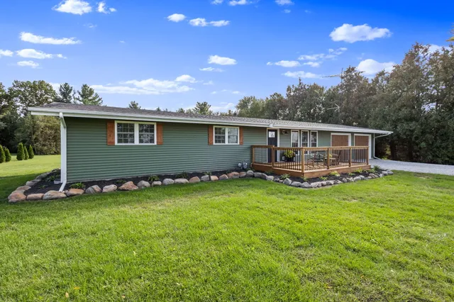 a front view of house with yard barbeque and outdoor seating
