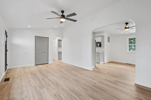 a view of an empty room and wooden floor