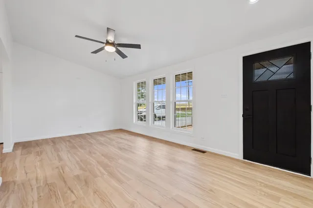 wooden floor in an empty room with a window