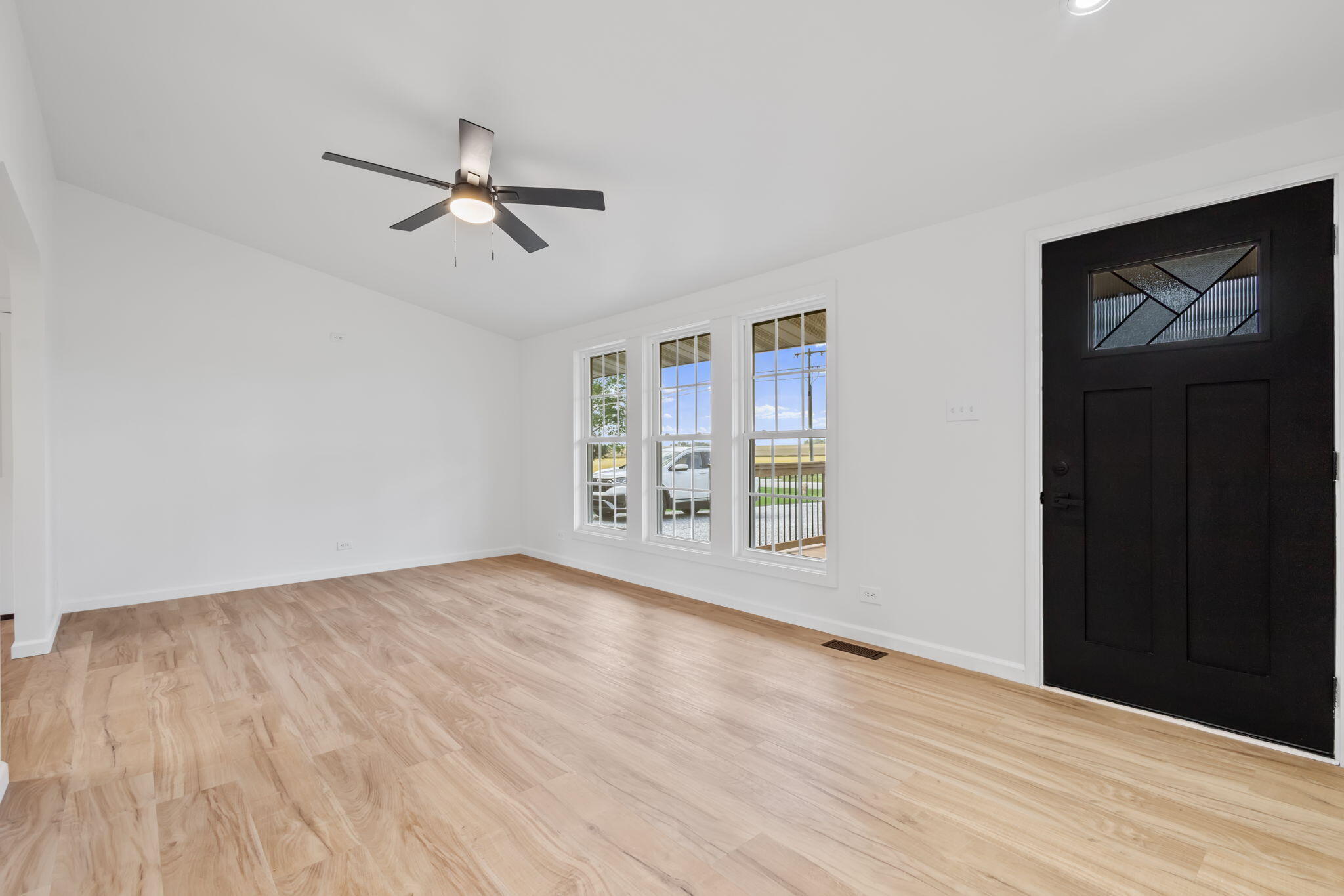 229 West Wood Road Rensselaer, IN 47978 - Photo 6 of 23 wooden floor in an empty room with a window