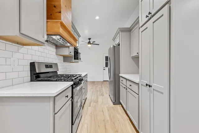 a kitchen with a sink stove and refrigerator