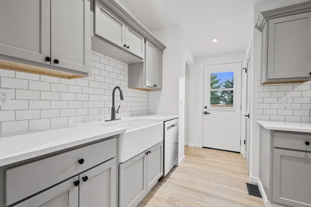 a kitchen with a sink and cabinets