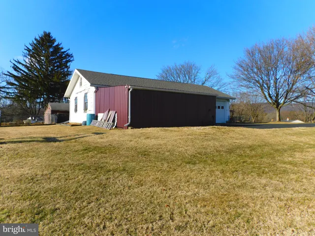 a front view of house with yard and trees