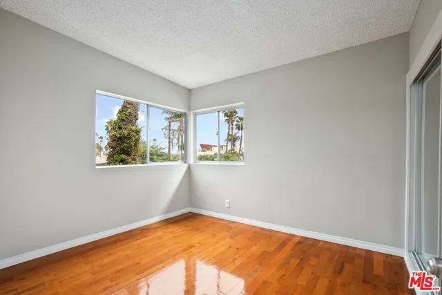 a white cabinet with a black white wall next to a white cabinet door