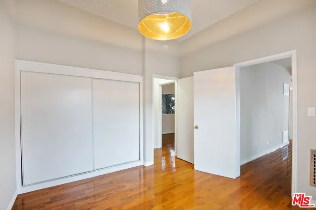 a view of room with window and wooden floor