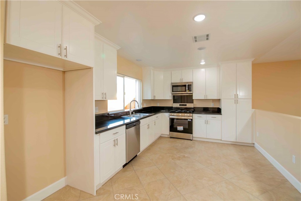 2523 Maynard Drive Duarte, CA 91010 - Photo 53 of 61 a kitchen with stainless steel appliances granite countertop a refrigerator a stove top oven a sink and dishwasher
