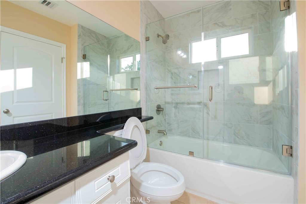 2523 Maynard Drive Duarte, CA 91010 - Photo 60 of 61 a bathroom with a granite countertop sink a toilet a mirror and bathtub