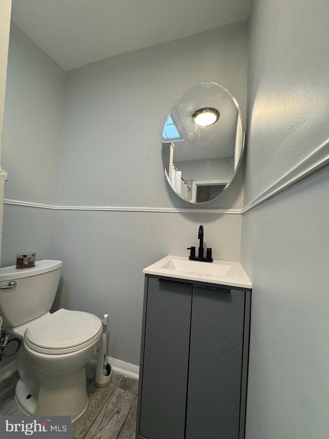 5502 Crowson Street Philadelphia, PA 19144 - Photo 14 of 16 a bathroom with a toilet a sink and mirror