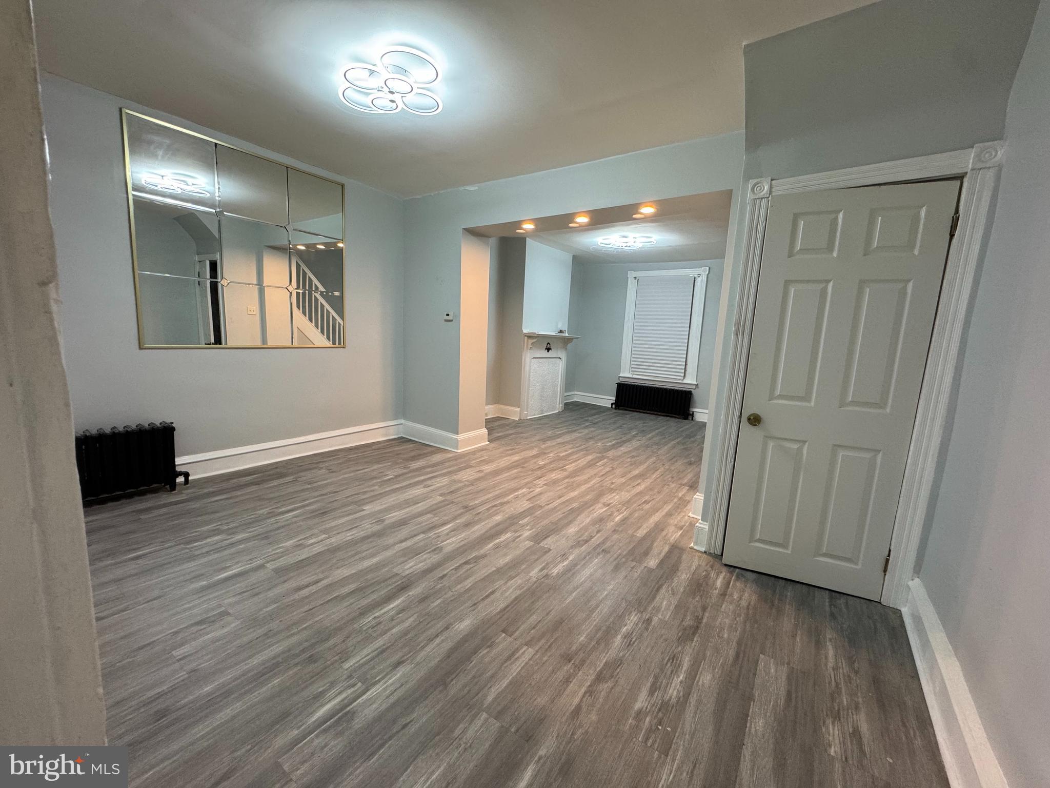 5502 Crowson Street Philadelphia, PA 19144 - Photo 4 of 16 an empty room with wooden floor and windows