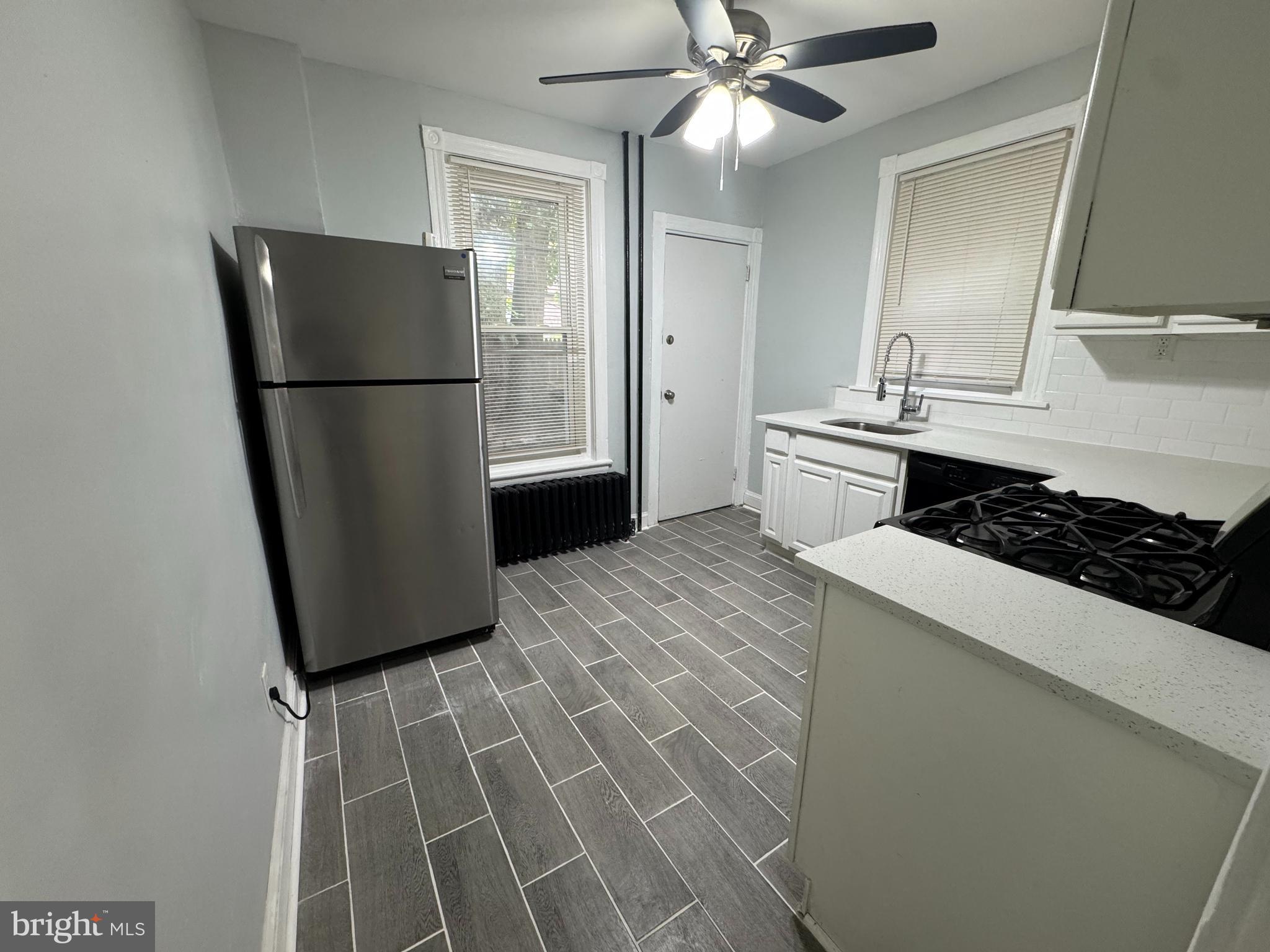 5502 Crowson Street Philadelphia, PA 19144 - Photo 5 of 16 a kitchen with a refrigerator and a sink