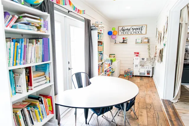 a dining room with furniture and a book shelf
