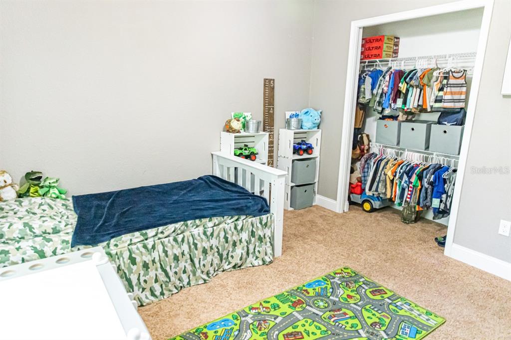 1533 County Road 13 Bunnell, FL 32110 - Photo 20 of 49 a bed room with a bed and a book shelf