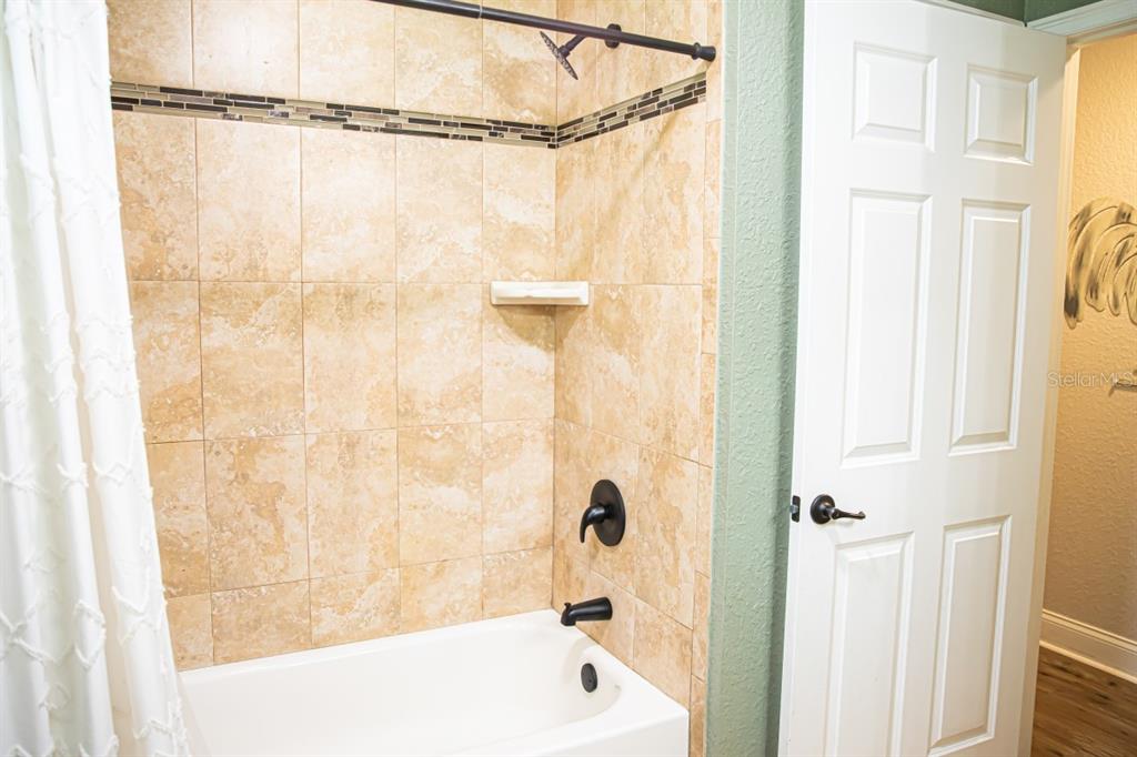 1533 County Road 13 Bunnell, FL 32110 - Photo 24 of 49 a bathroom with a shower and a bathtub