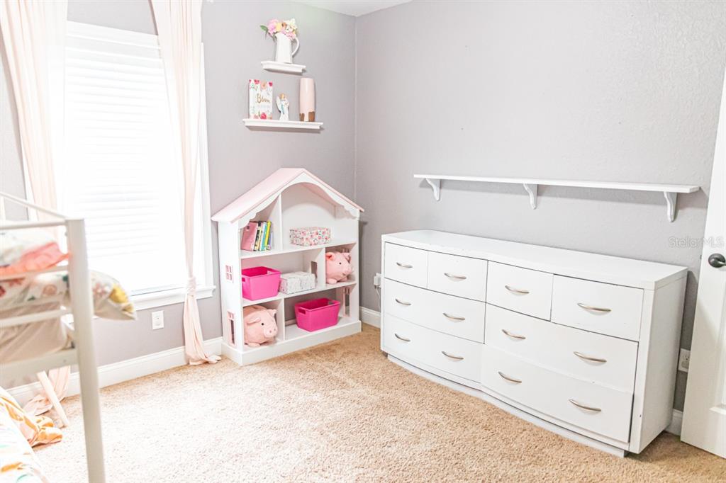 1533 County Road 13 Bunnell, FL 32110 - Photo 26 of 49 a view of a bedroom with baby bed and cabinet