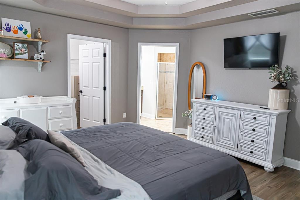 1533 County Road 13 Bunnell, FL 32110 - Photo 30 of 49 a bedroom with a bed and a flat screen tv