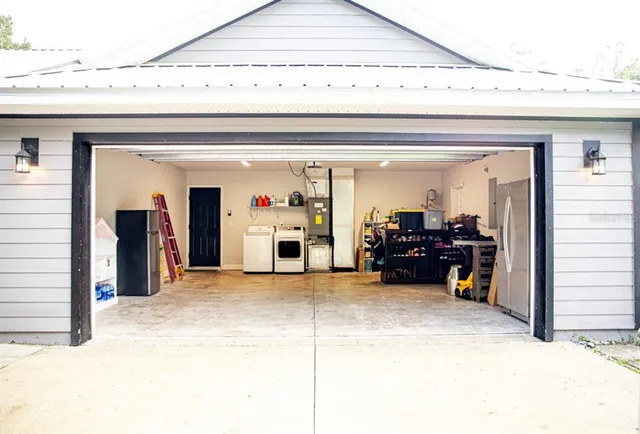 a view of a room with furniture and a chandelier