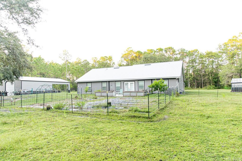 1533 County Road 13 Bunnell, FL 32110 - Photo 43 of 49 a view of a house with backyard and a garden