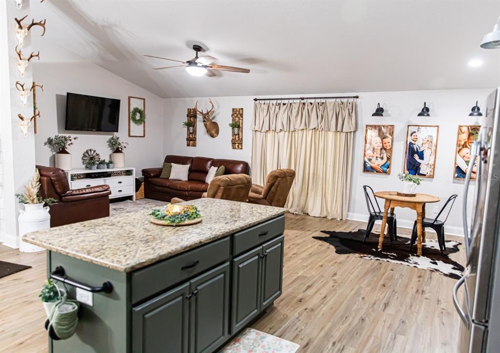 1533 County Road 13 Bunnell, FL 32110 - Photo 6 of 49 a view of kitchen island wooden floor and living room