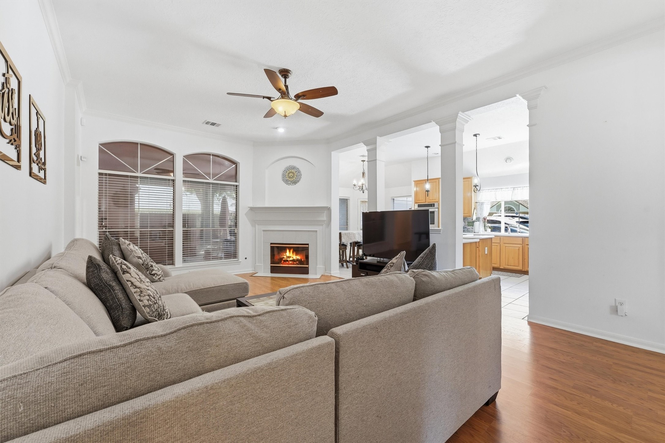 18811 Racquet Sports Way Humble, TX 77346 - Photo 3 of 28 Spacious living room with beautiful arches and a fireplace centrally located.