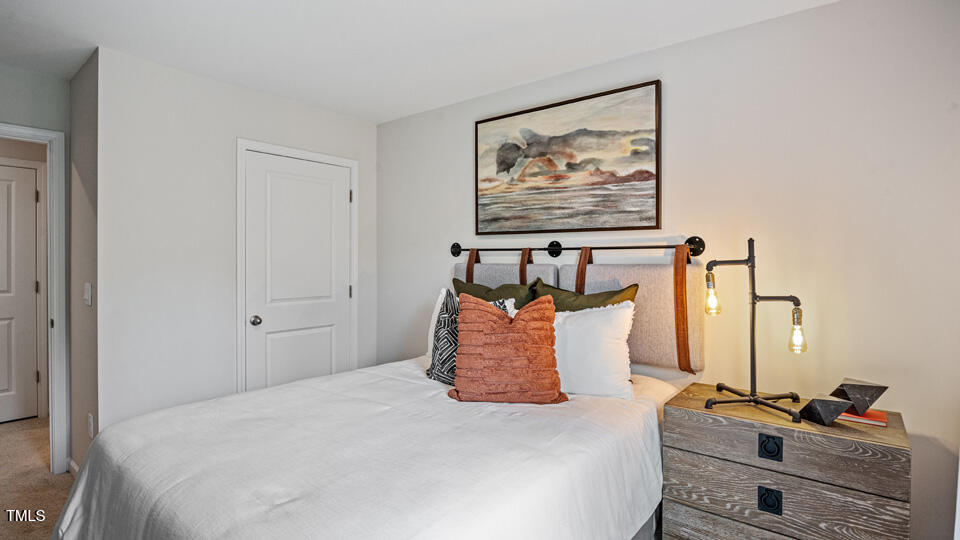 417 Belgian Red Way Wake Forest, NC 27587 - Photo 20 of 30 a bedroom with a bed and a painting on the wall