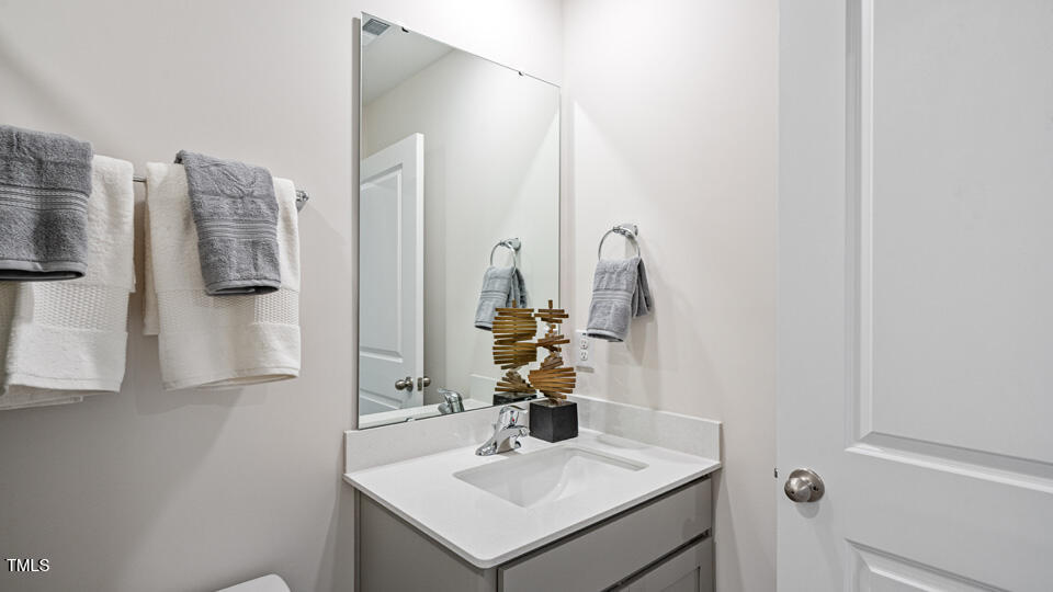 417 Belgian Red Way Wake Forest, NC 27587 - Photo 22 of 30 a bathroom with a sink vanity and a mirror