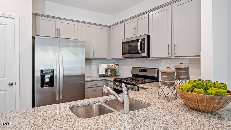 417 Belgian Red Way Wake Forest, NC 27587 - Photo 6 of 30 a kitchen with stainless steel appliances granite countertop a refrigerator a stove a sink a microwave and cabinets