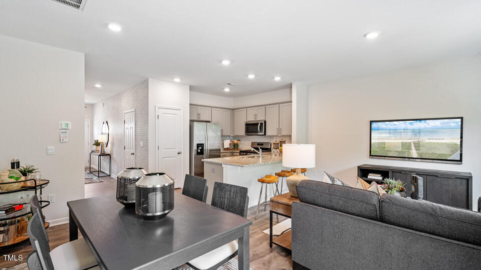 417 Belgian Red Way Wake Forest, NC 27587 - Photo 9 of 30 a living room with lots of furniture and kitchen view