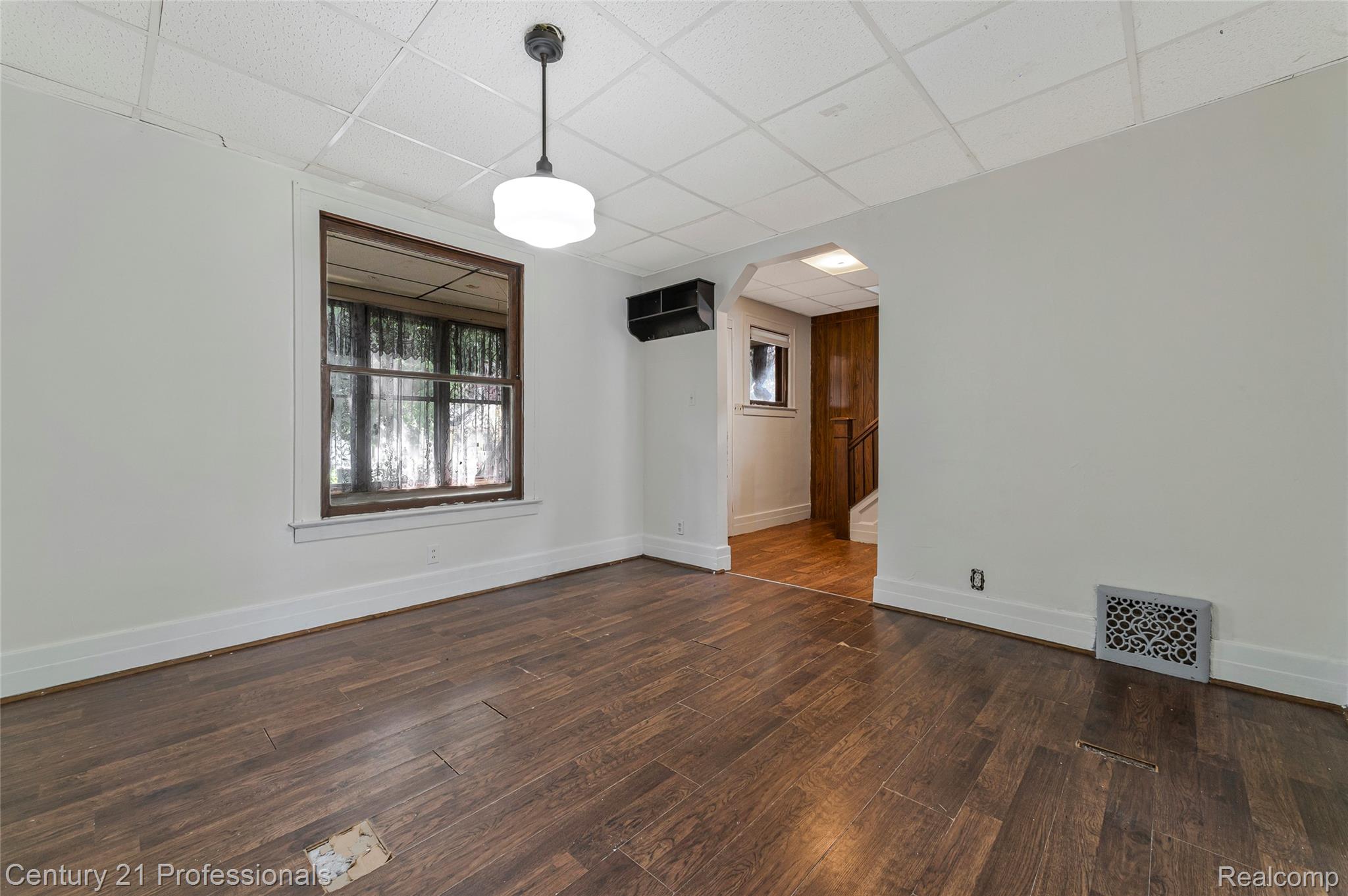 238 Richter Street River Rouge, MI 48218 - Photo 11 of 33 Interior room featuring wood-finish flooring, white baseboards, and a white drop ceiling