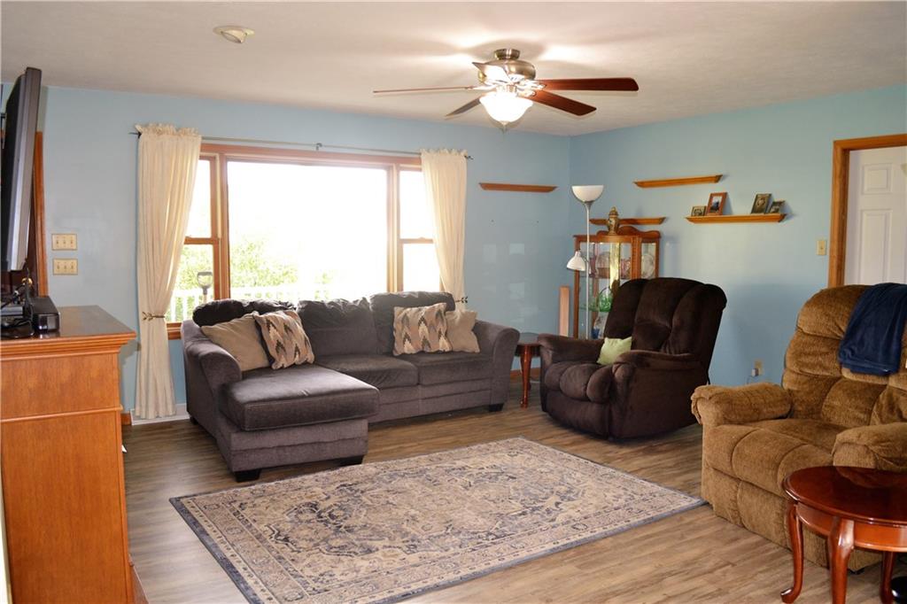 192 Elderton Heights Road Elderton, PA 15736 - Photo 3 of 20 Living room with large picture window, ceiling fan, gas fireplace, and LVP flooring