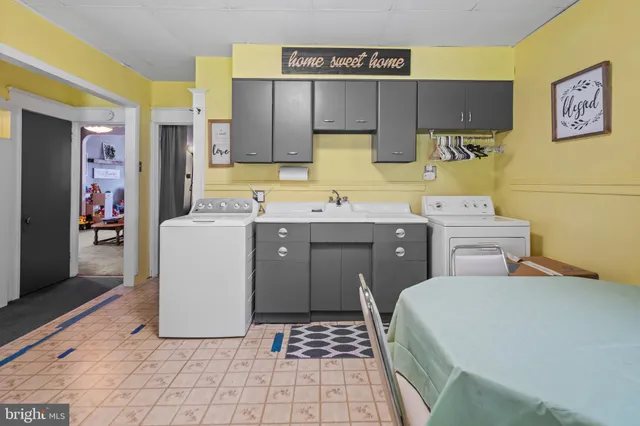 a utility room with a sink a washer and dryer