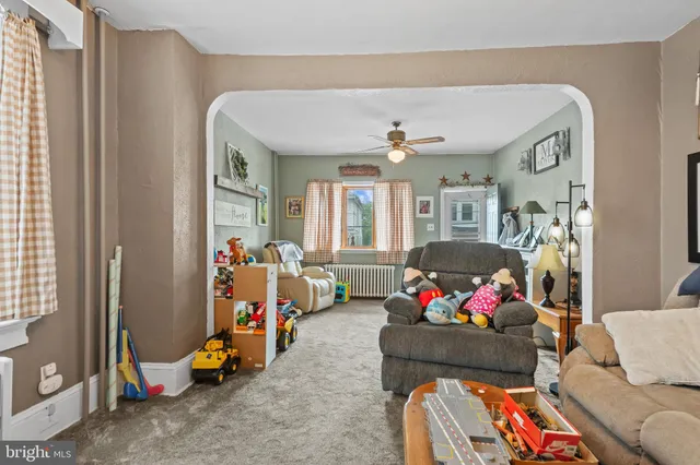a living room with furniture a couch and dresser