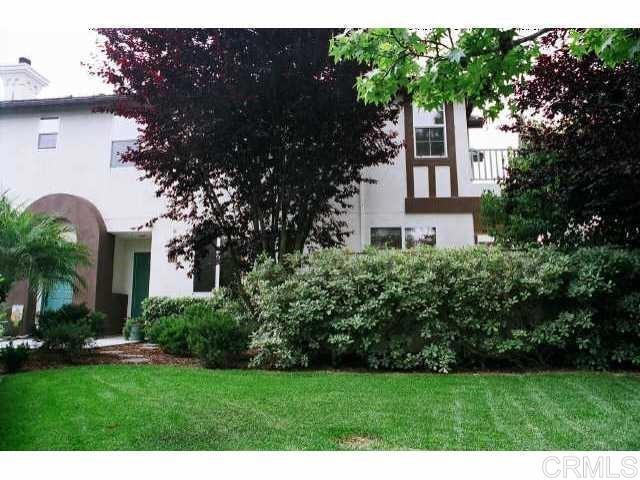 442 Carmel Creeper Place Encinitas, CA 92024 - Photo 8 of 12 a front view of a house with a yard