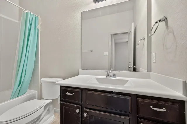 a bathroom with a tub sink and mirror