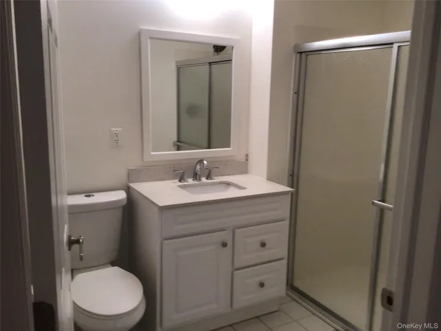 a bathroom with a sink toilet vanity and a mirror