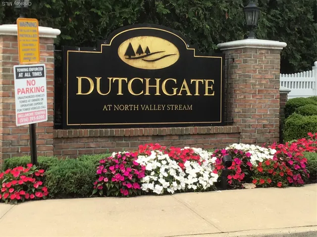 a sign that is in front of flowers