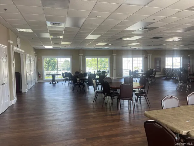a large hall with dining table and chairs
