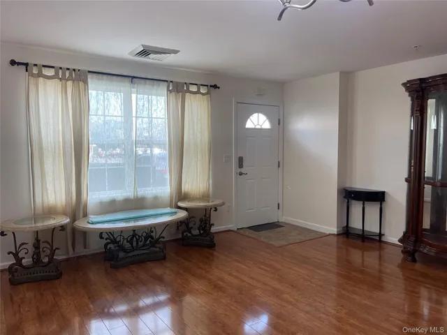 a living room with furniture window and wooden floor